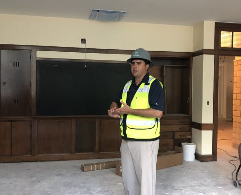 Divens stands in front of the casework in one of the restored classrooms