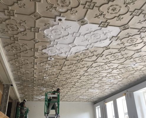 The IFACS team works to repair the Historic Classroom's ceiling