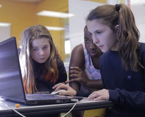 Three students working together on a computer project
