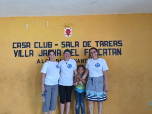 Maria Coady with Amber Peretz (UF COE ProTeach student) and Ava Long (UF) with a student in Santiago, Dominican Republic.