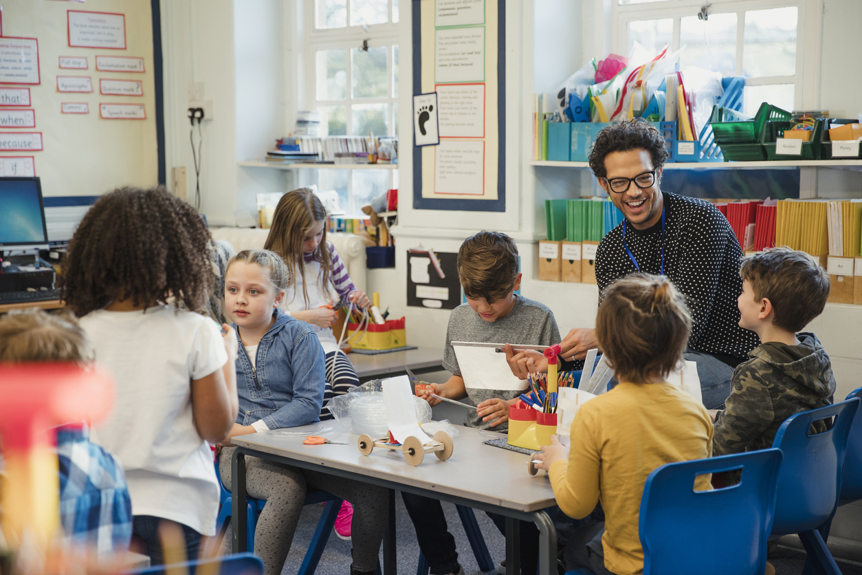 Elementary school children build 3d models using recycled materials with their teacher during class. This is a school in Hexham, Northumberland in north eastern England.