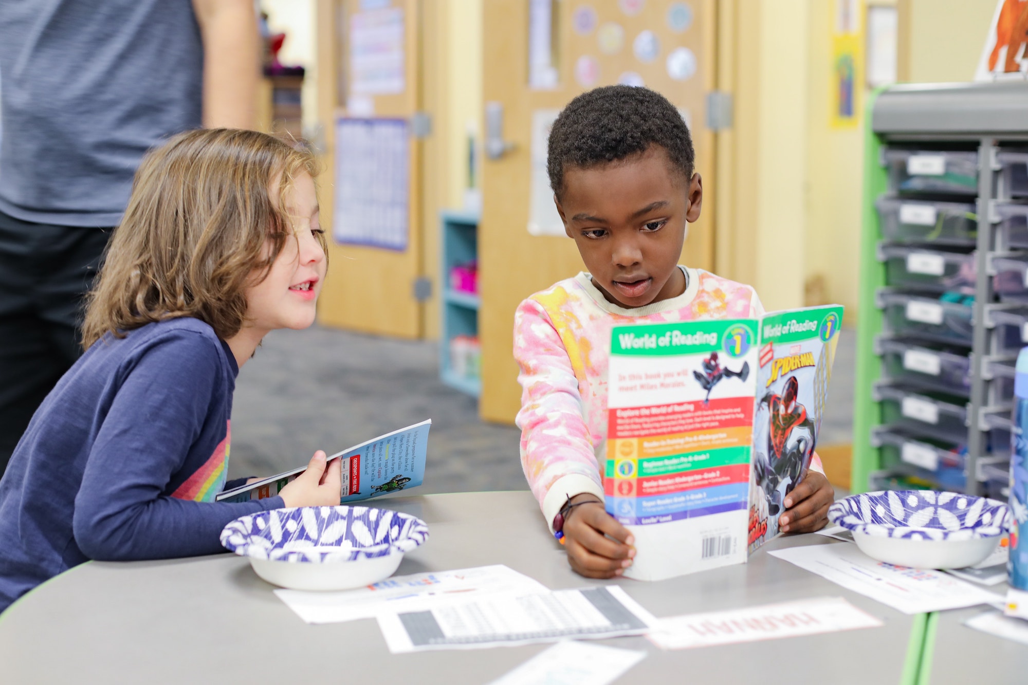 Four people looking at an iPad together and smiling.