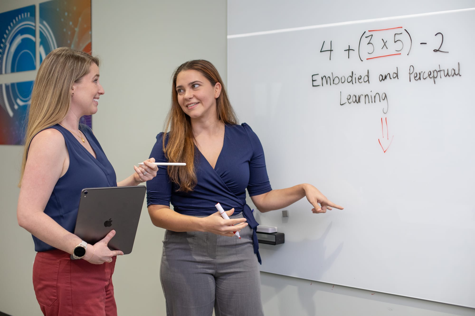 Avery and Daryn at University of Florida discussing math in a conference room