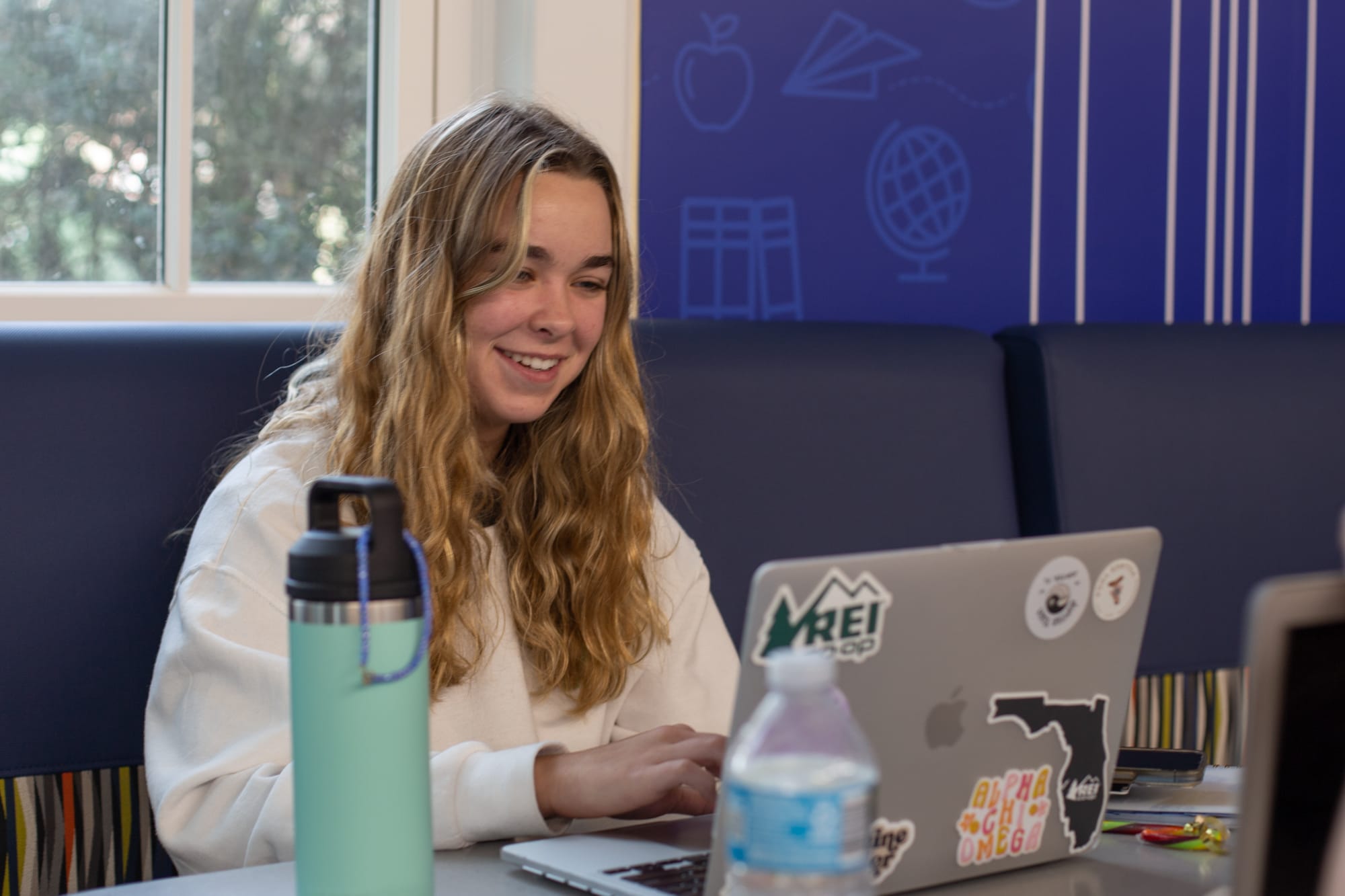 UF College of Education student studying in Norman Hall on a laptop