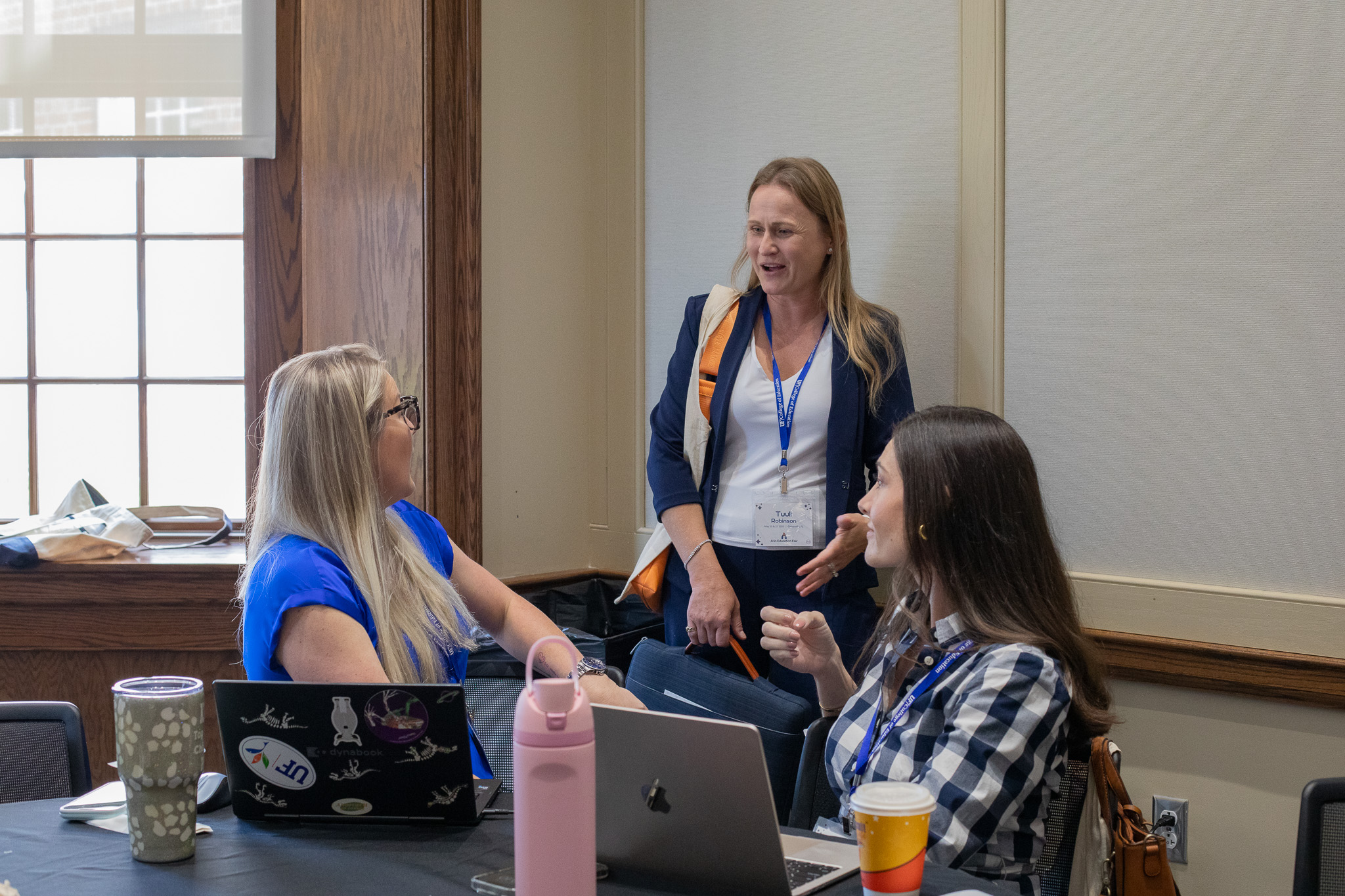 Ed tech students discussing in the hallway