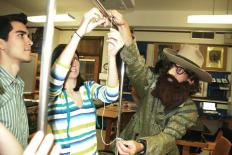Galileo helps students measure the string length for their pendulum motion experiment.