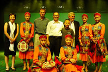 Dr. Oakland, posing with a dance team comprised of schoolchildren