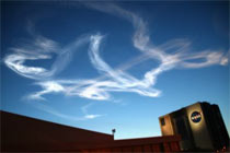 Remnants of contrail pain from the shuttle, as seen above the NASA News Center