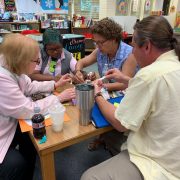 Teachers collaborate on a team-building activity.