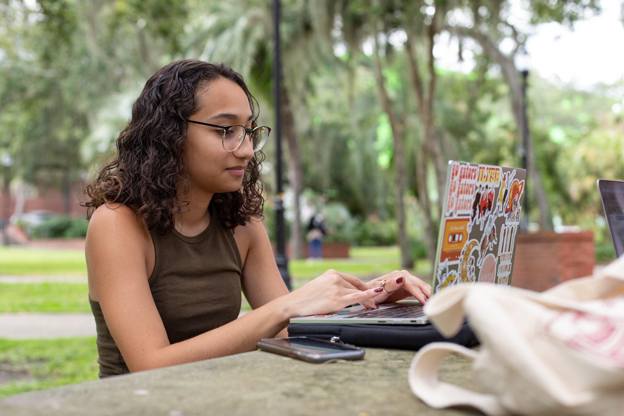a teacher instructing a student on how to use a laptop