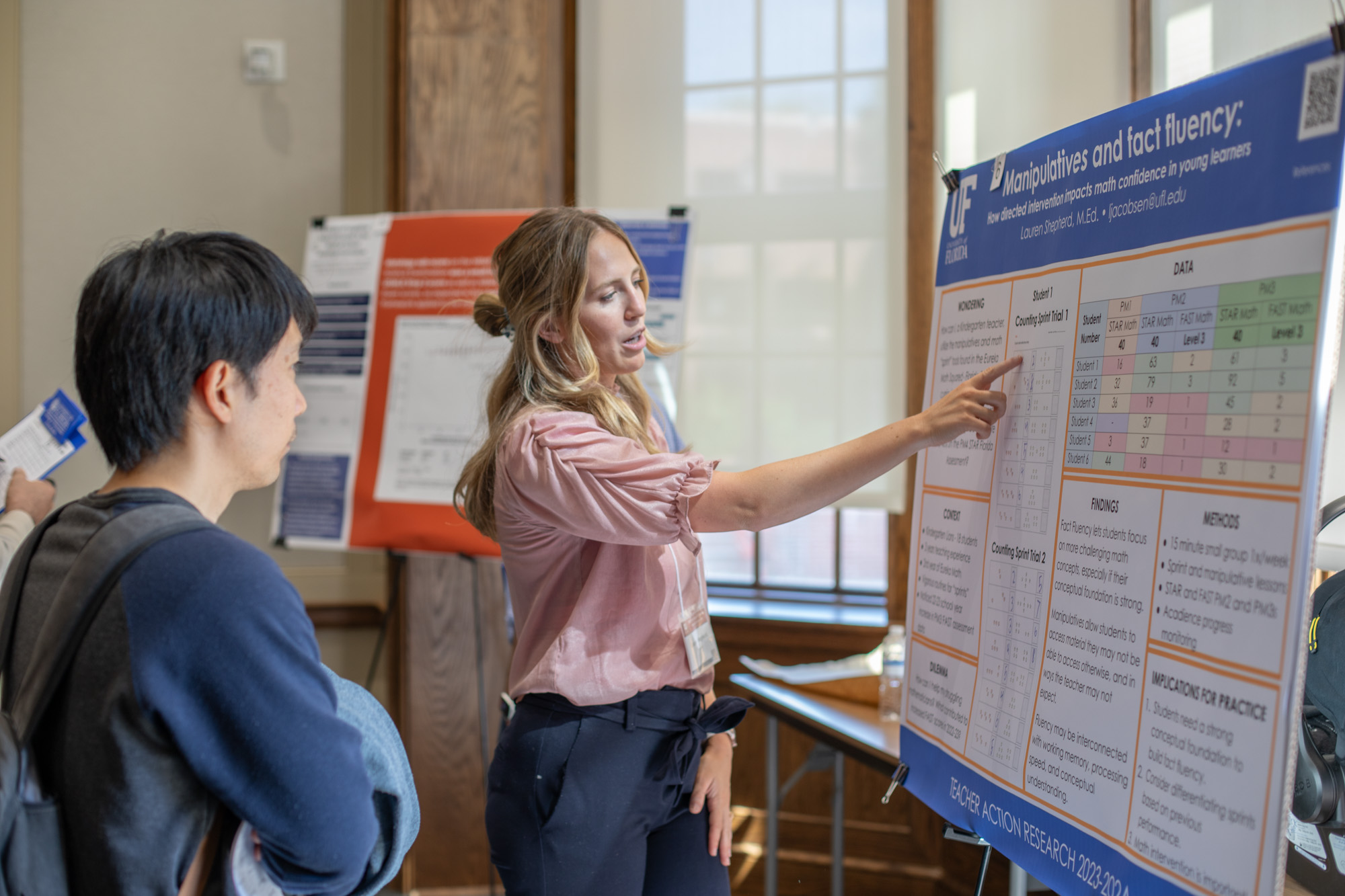 Four people looking at an iPad together and smiling.