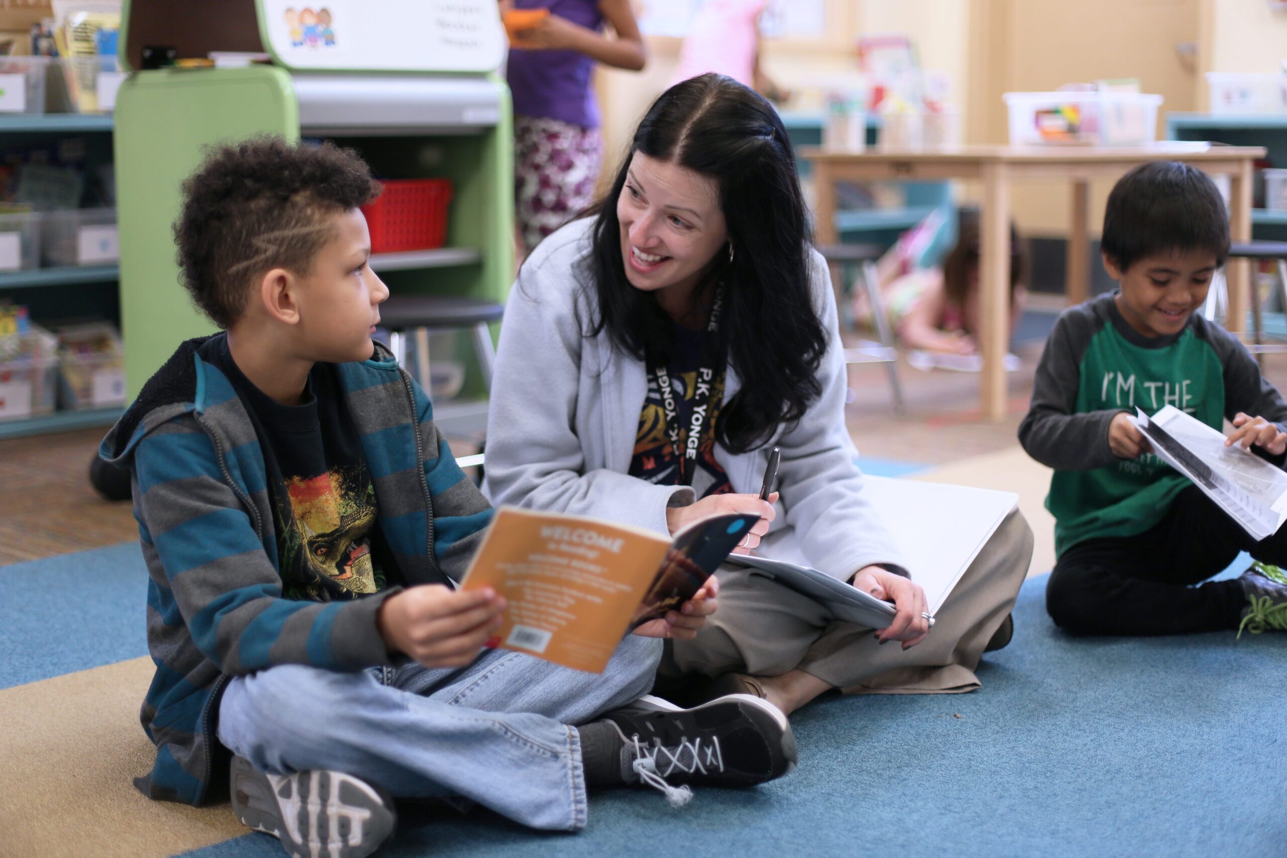 Teacher reading a book with a elementary school student
