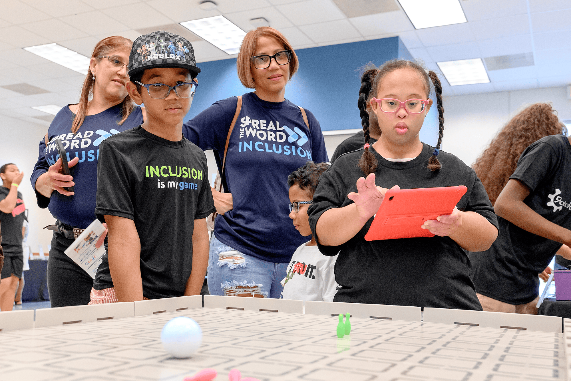 A special education teacher reaching a kid in a classroom