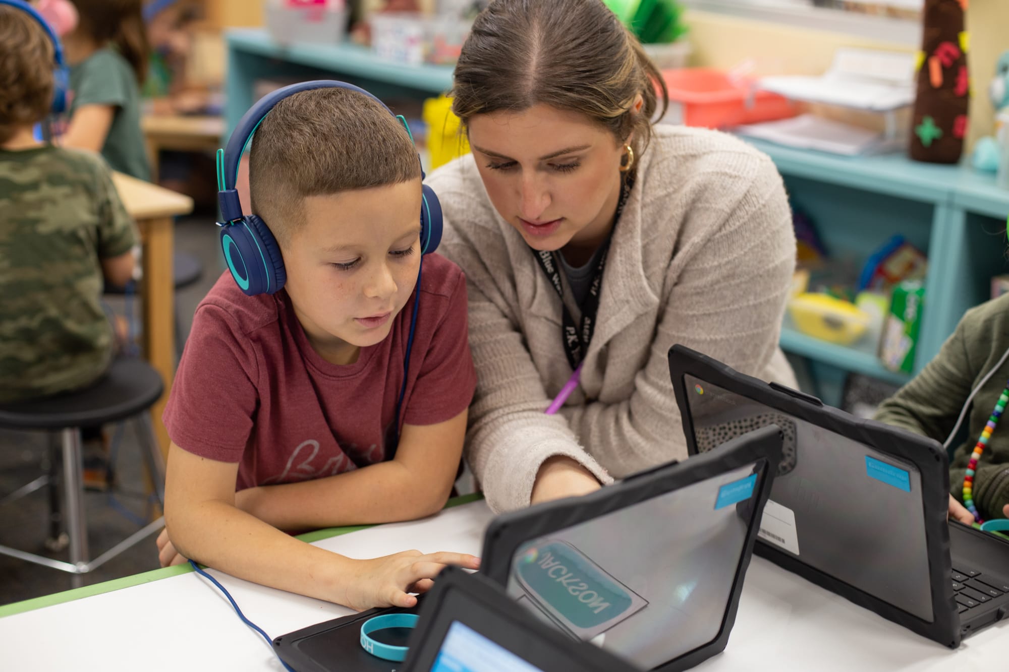 Teacher teaching an elementary kid