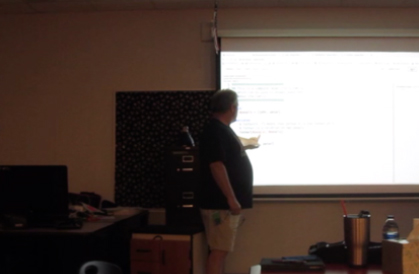 A man presenting on a screen.